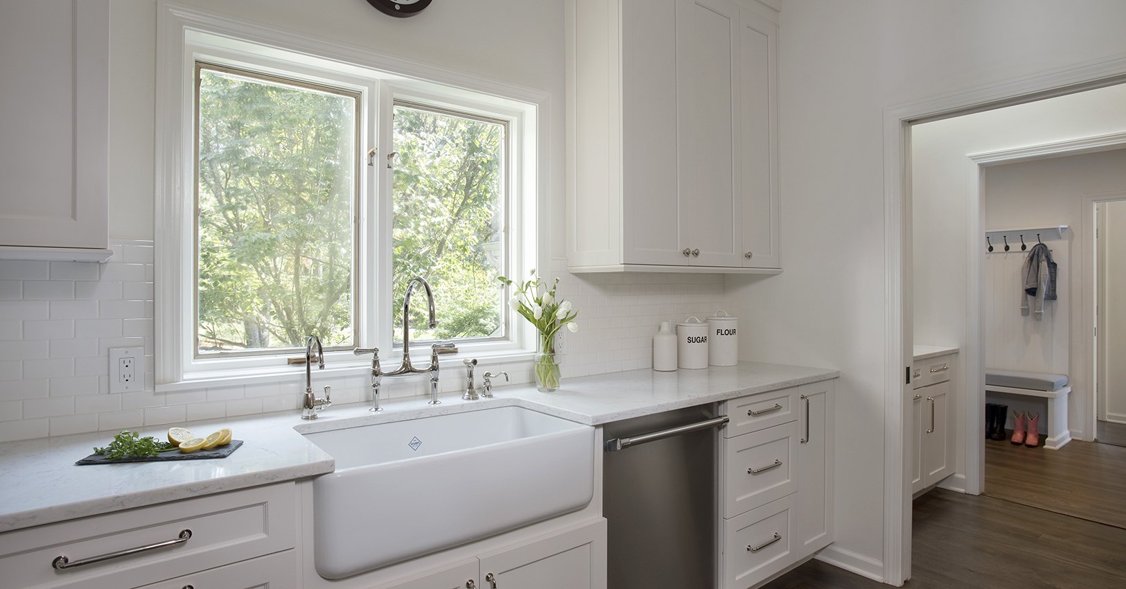 Rohl white farm sink grounds this sink elevation in this kitchen redesign