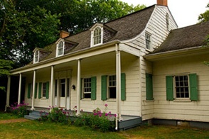 Vintage home with center gable and recent construction activity.