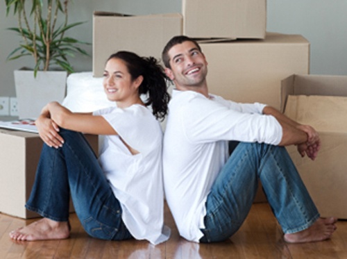  couple waiting to unpack moving boxes