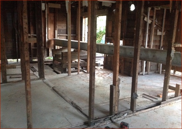 I beams support the house as it is lifted.
