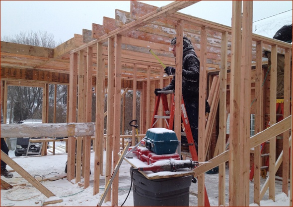 interior framing continues despite a snow storm.