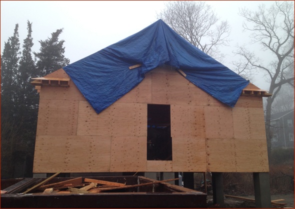 cottage is tarped from the rain