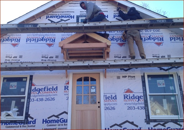 House wrap is on and siding installation begins.