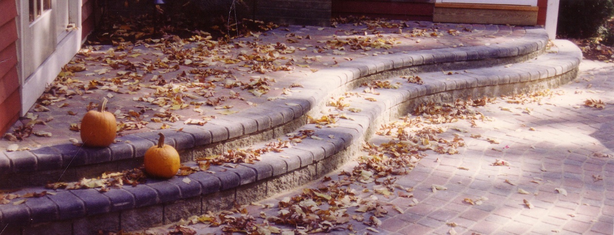 Clark Construction patio with two curved steps and pumpkins in Fairfield County CT