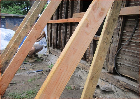 Work is under way to remove the sill plate on the right side of the home in this 1700's home being renovated by Clark Construction of Ridgefield.