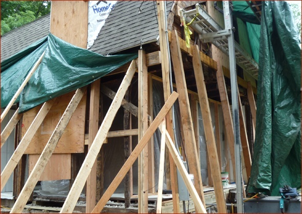 Extensive temporary supporting and tarps keep the house safe while remedial repairs occur.
