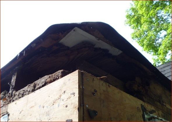Detail of rotted framing on the corner near the roof.
