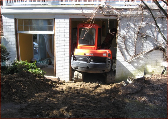 Excavator squeezes through the opening. 