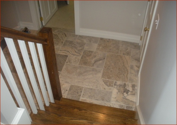 Combination of wood and stone at the base of the stairs.