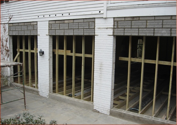 Masonry openings framed down to provide standard height door openings.