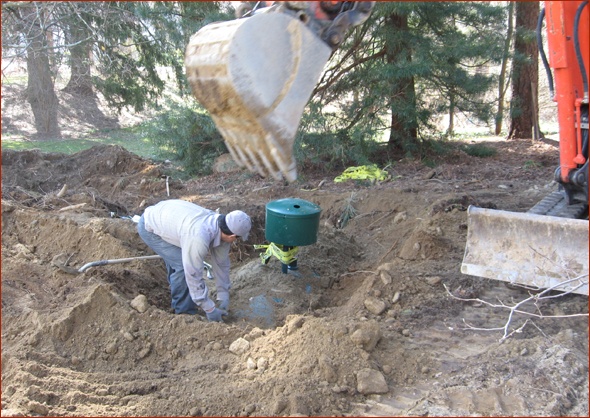 Man and tank work together to fill the hole.