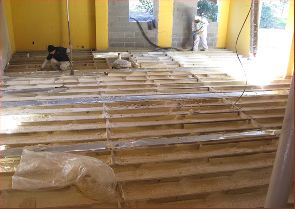 The insulator prepares to spray closed cell foam.