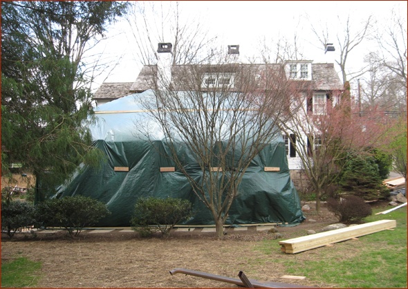 Massive tarps cover the site.