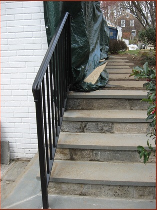 Wrought iron rail dresses up the steps at this New Canaan Ct. home, renovated by Clark Construction.