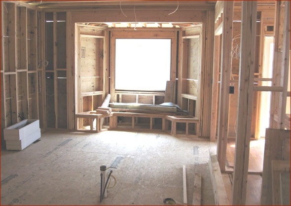 Kitchen bay window and window seat have been framed.