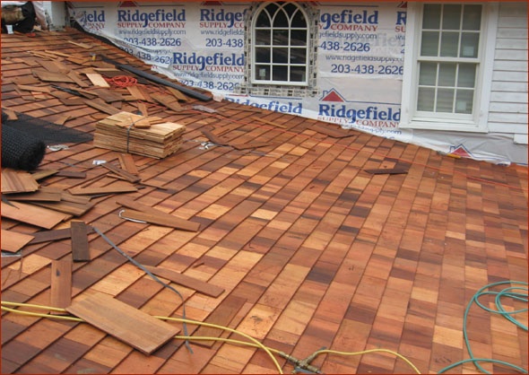 Cedar shakes being installed on this New Canaan, Ct, home being renovated by Clark Construction