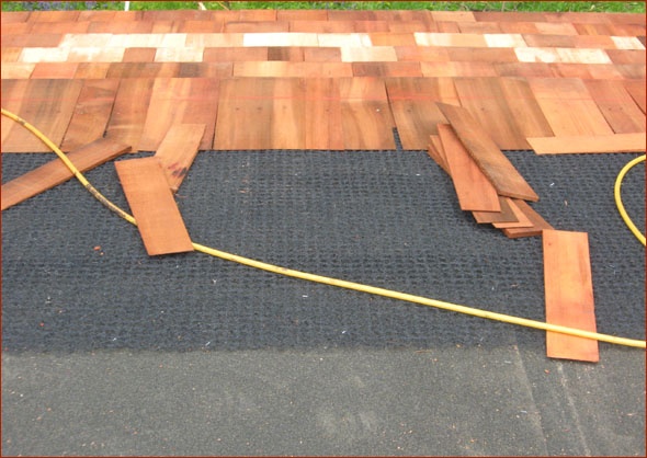Ice and water shield is being applied atop the plywood.