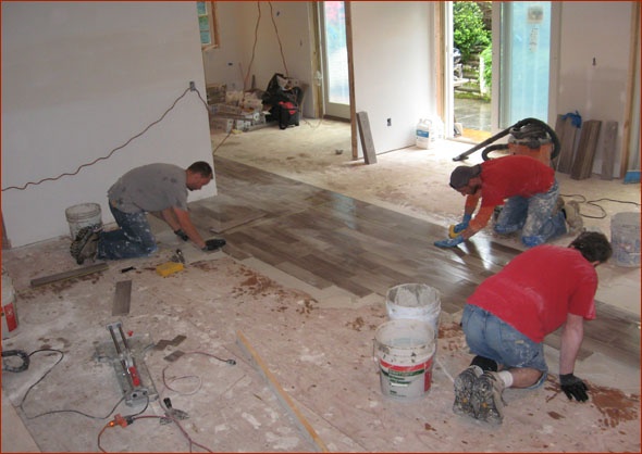 Tile installation on lower level of this New Canaan, CT home being renovated by Clark Construction