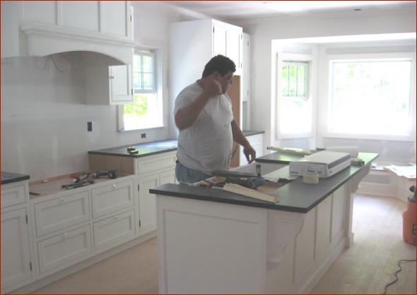 Granite counter installation in the kitchen remodel of this New Canaan, CT home renovated by Clark Construction.