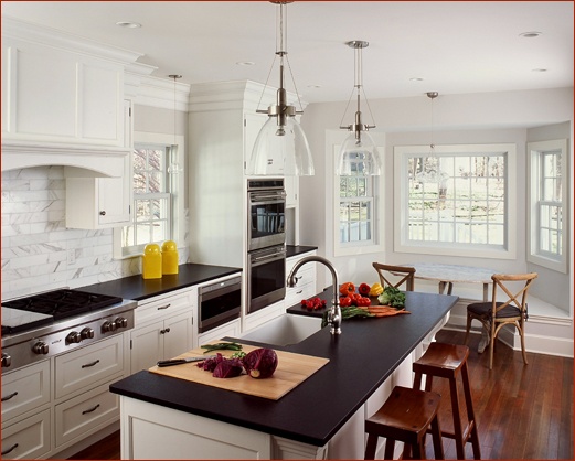 New Canaan CT kitchen design features a window seat and island stools from Clark Construction.
