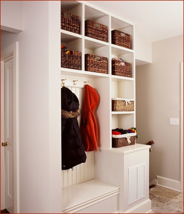 Mud room cabinetry organizes muddy shoes and snow covered books on this New England historical home.