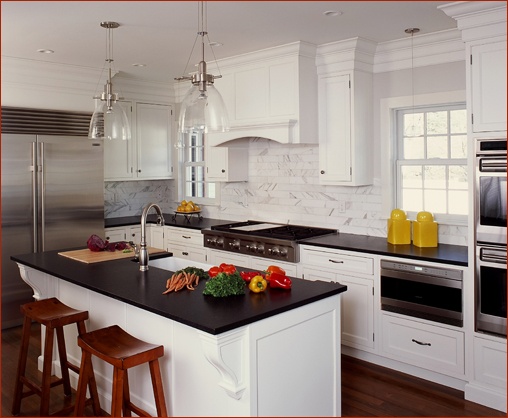 Clark  Construction's kitchen renovations include furniture style details such as arched toe valences, side panels and decorative corbels in New Canaan CT