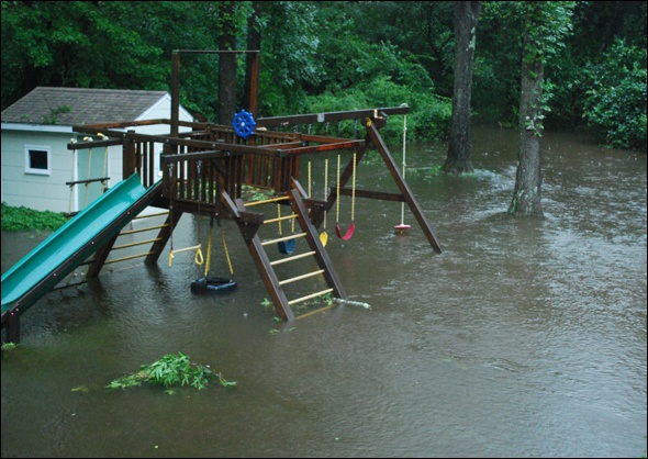 Submerged swingset in backyard.