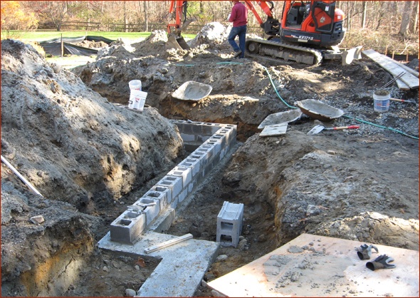 The foundation begins with one course of block.