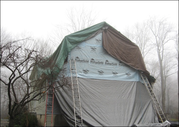 Oversized tarps cover the addition during construction.