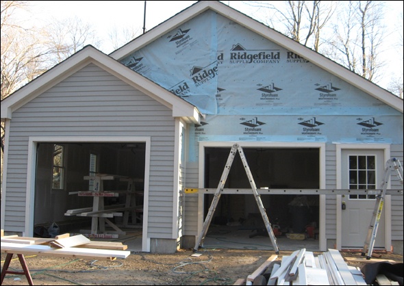 partially completed siding on garage