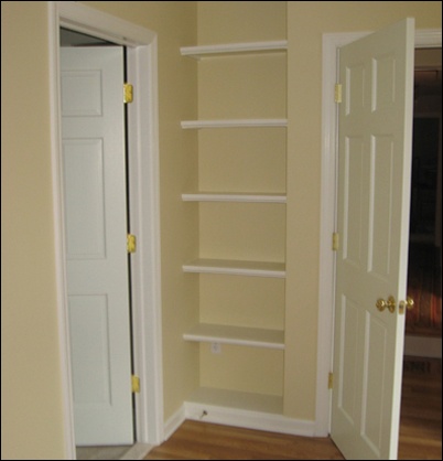Bookshelves behind the master bedroom door