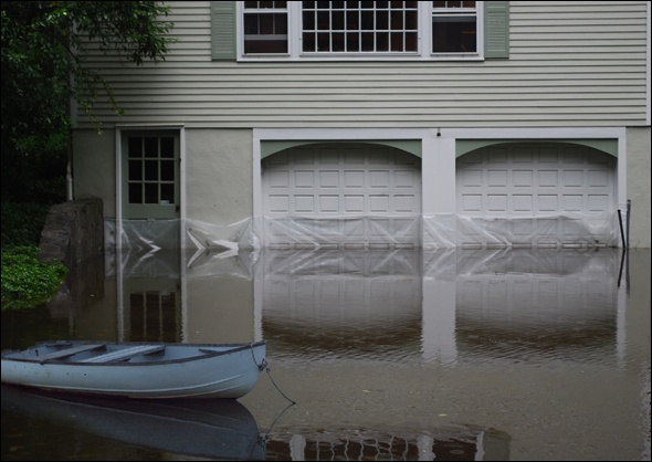 Flooded driveway with blue boat
