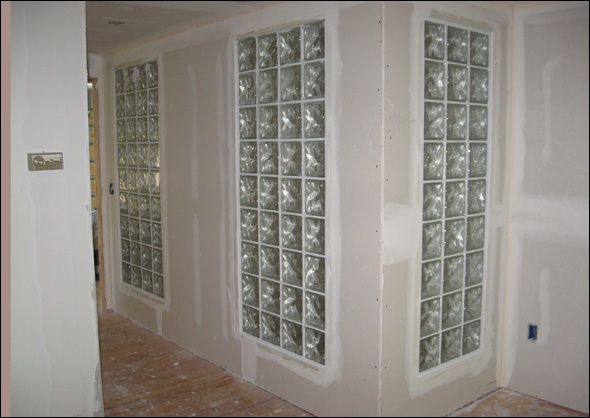 Glass block in hallway walls gives a nod to the original architect's vision