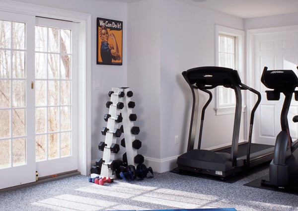 Custom designed home gym after basement renovation with Clark Construction.