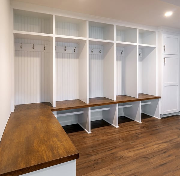 Custom built storage area in renovated basement by Clark Construction.