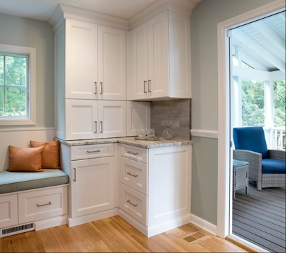 Corner cabinets and a banquette provide a lot of storage in Clark Construction's Wilton kitchen remodel.