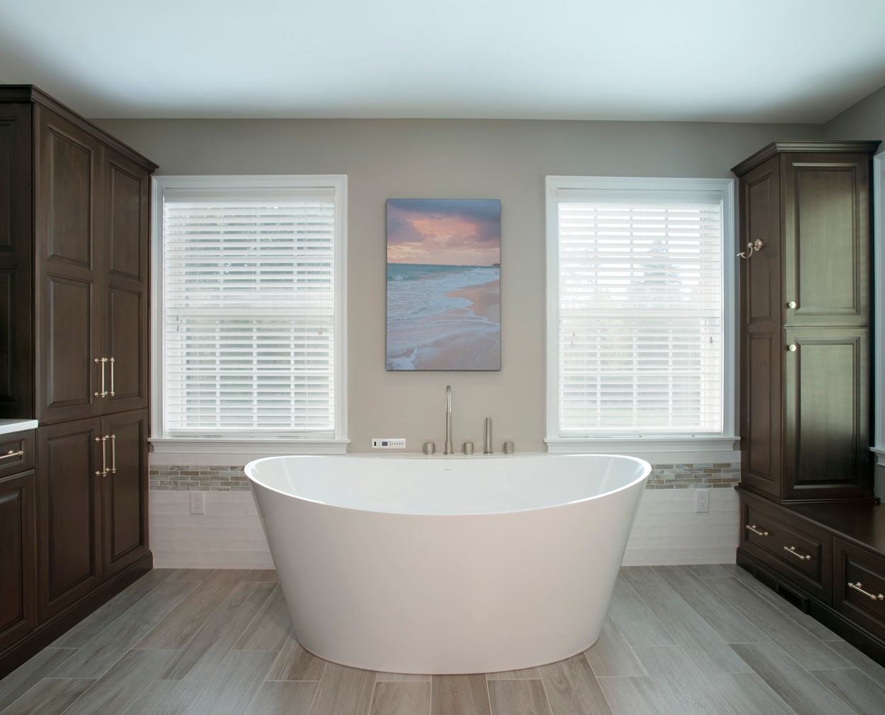 White freestanding tub with Grabill cabinets in a dark stain.