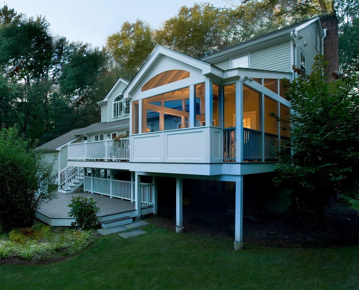 Dusk approaches and screen porch lights come on.