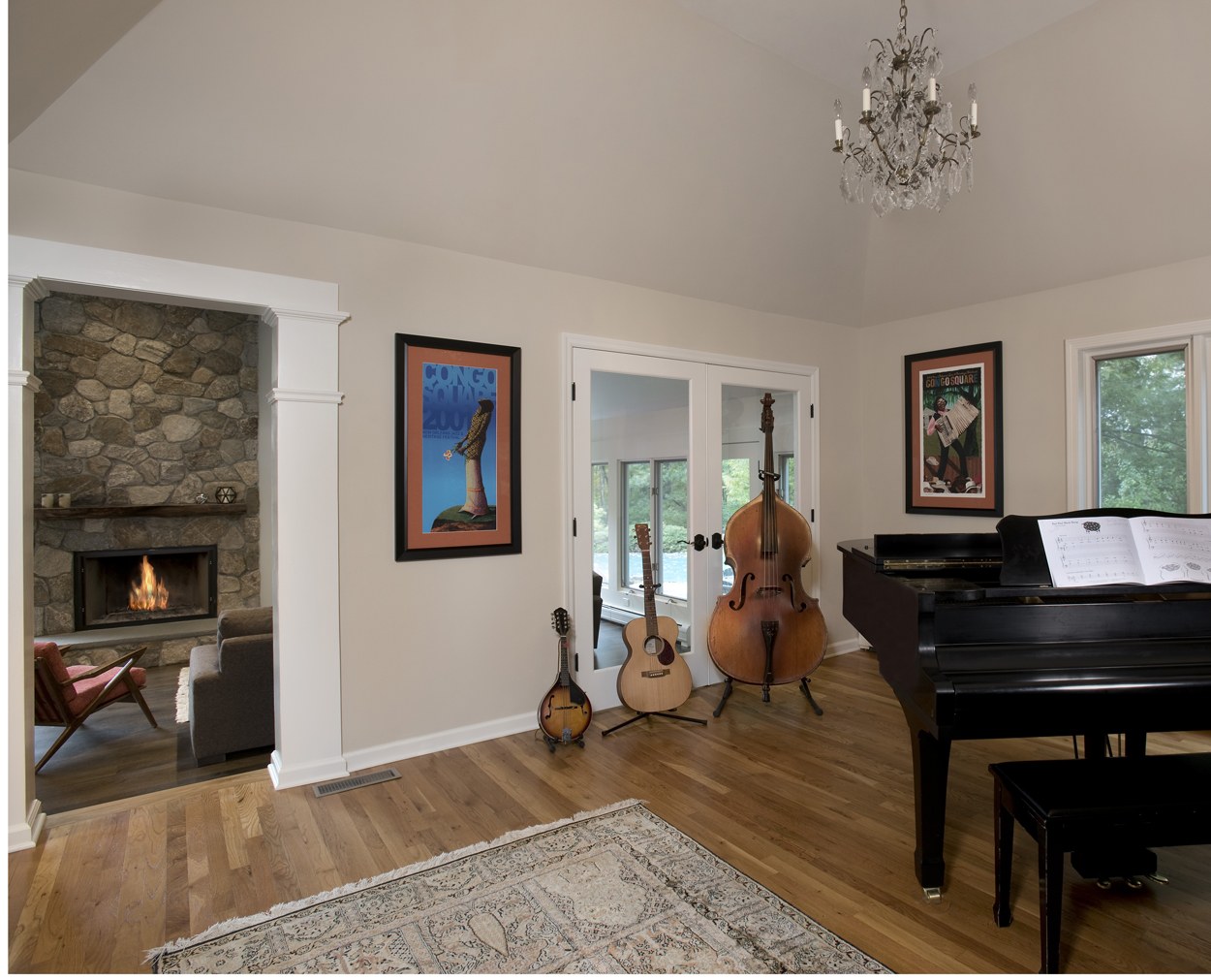 Fireplace is viewed through  a columned opening in this Ridgefield renovation.