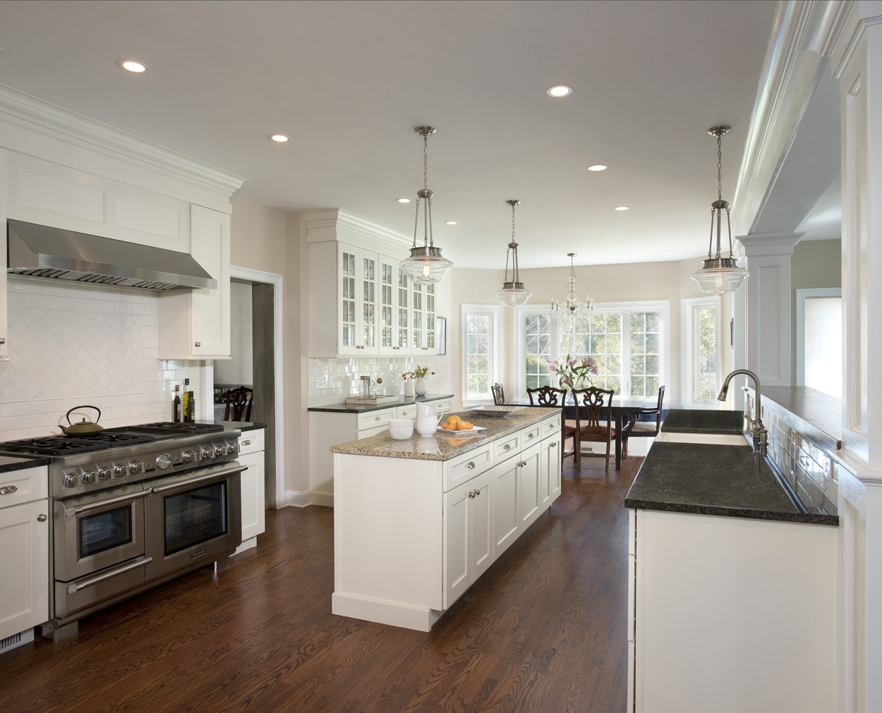 White kitchen with lots of glass doored storage in Clark Construction design