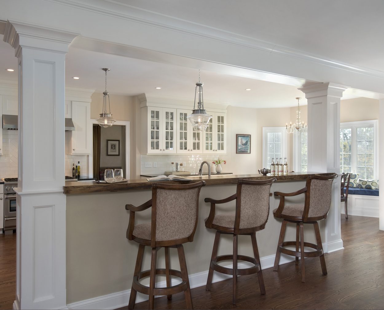 Walnut bar with live edge opens up this Clark Construction remodel.