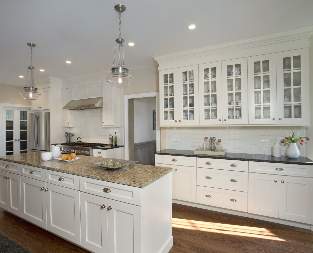 Hutch like display with glassware in a creamy shaker door style.