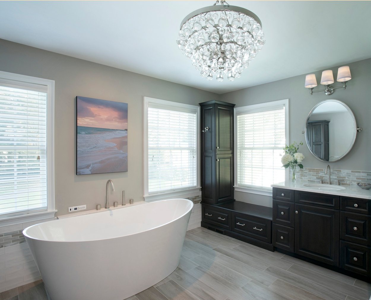 Dark cabinets and tall corner storage maximize the space in this master bath design.