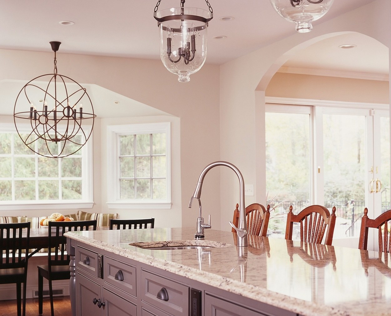 Center island features a prep sink and granite top.