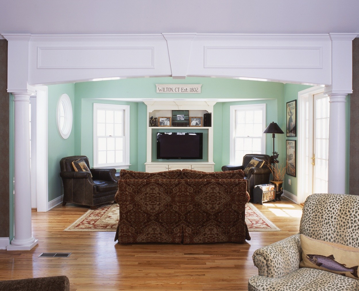 arched detailing and columns highlight the entrance to this media room