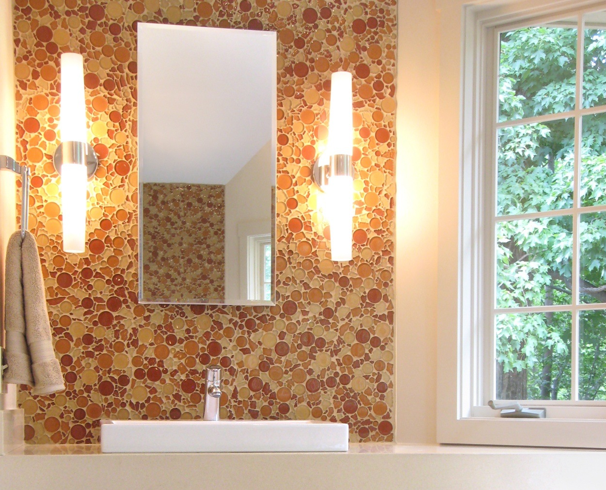 Circular glass tile and a cubed sink tops a custom vanity.