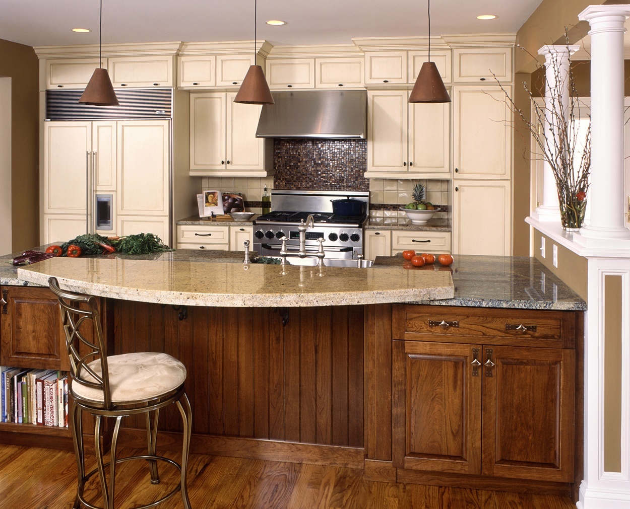 Bi level counter with glazed cabinets highlights this Clark Construction kitchen design.