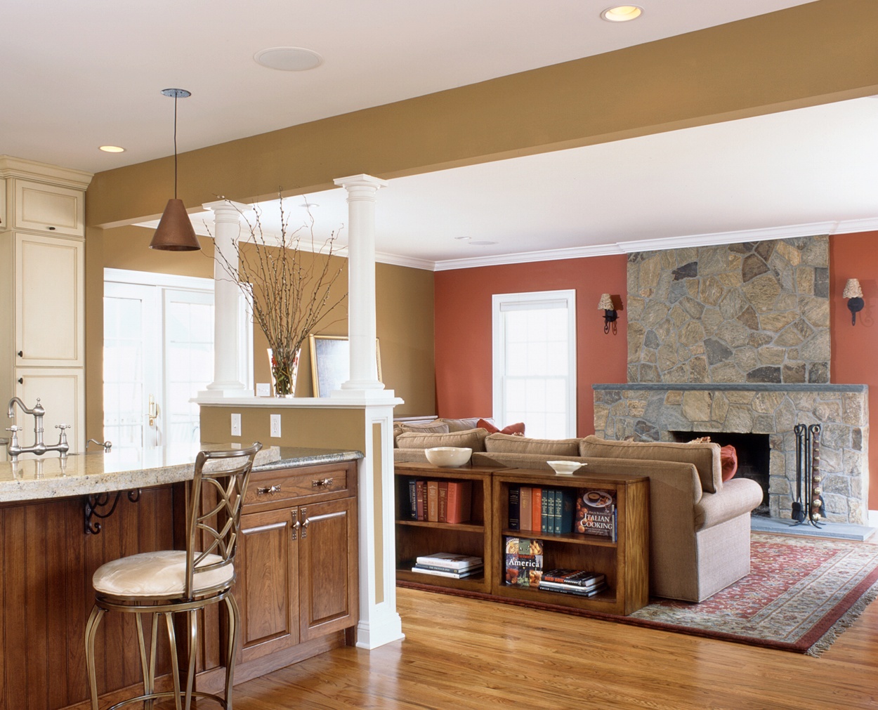 View from the kitchen to the livingroom towards the stone veneer fireplace.