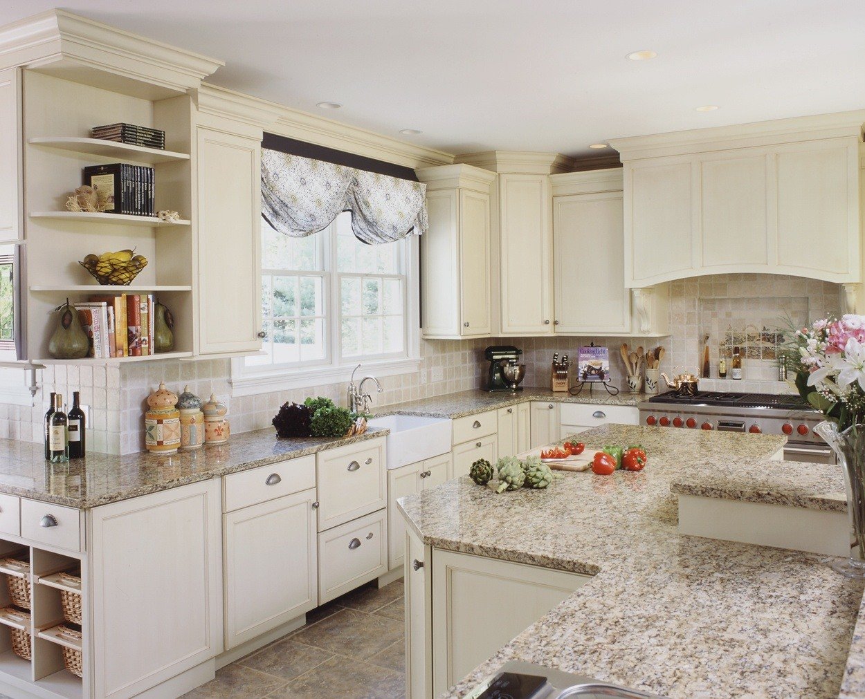 Creamy cabinets with a bi-level island and wrap around perimeter.