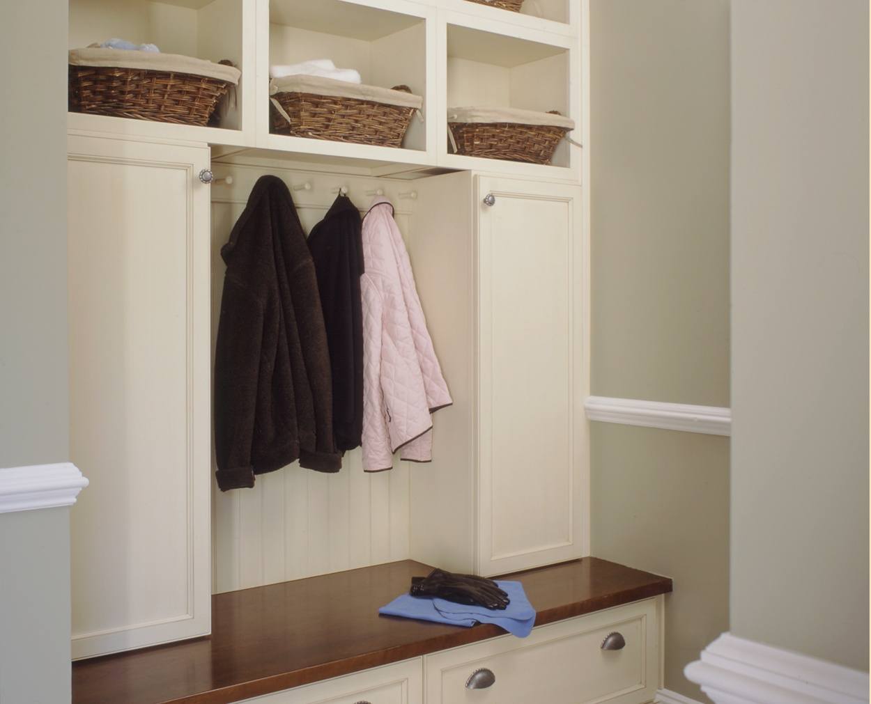 hooks and baskets and a solid wood top are the hightlight of this mudroom builtin.